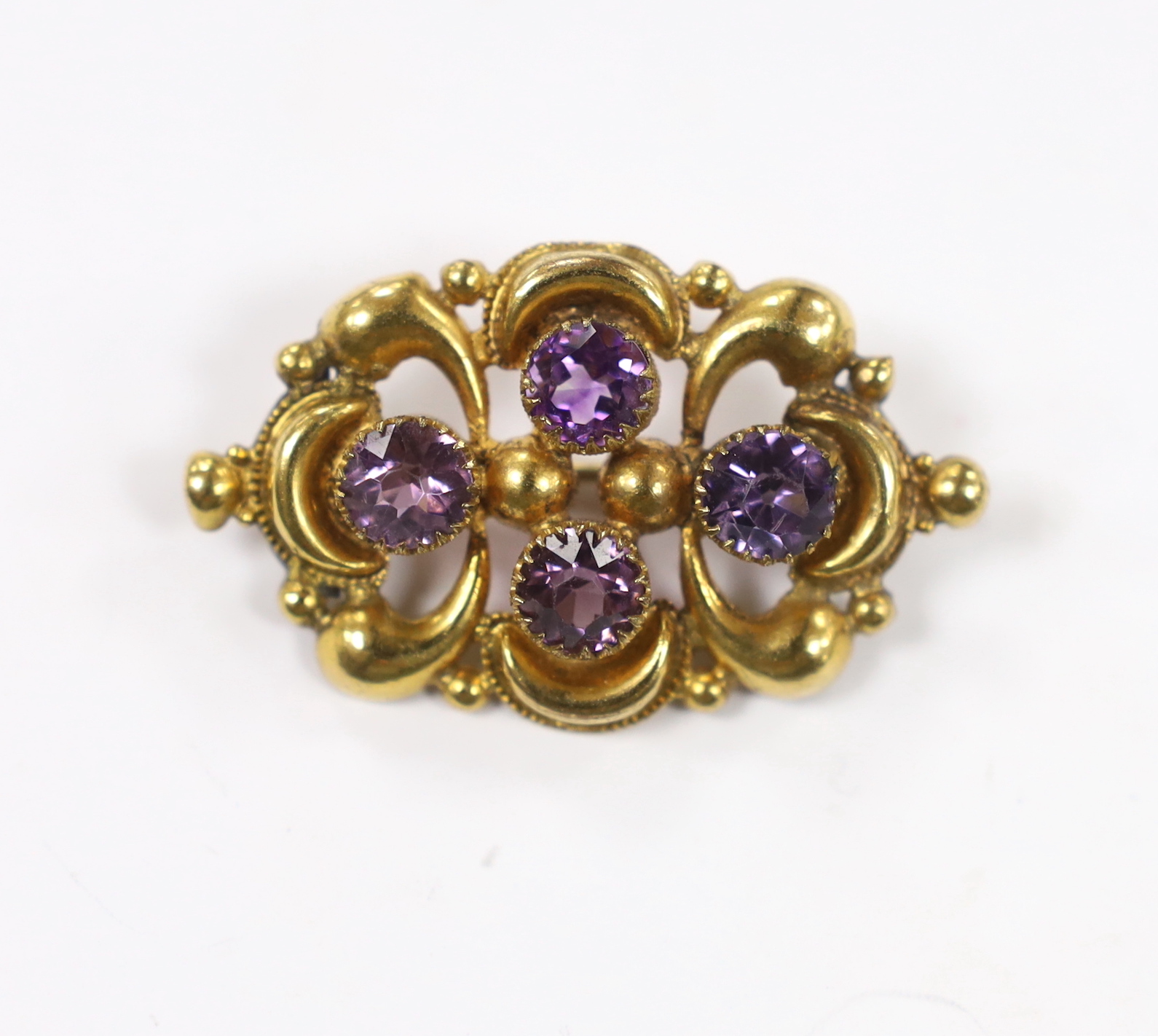 A late Victorian yellow metal and amethyst cluster set oval brooch, 45mm, gross weight 7.2 grams.